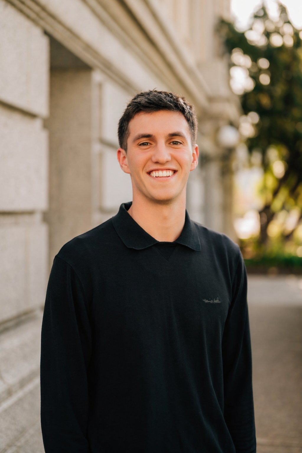 ATMOS founder, a BYU student, smiling outdoors